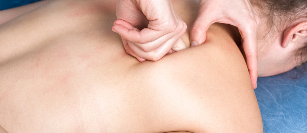 osteopath massaging back